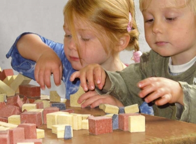 Anker Steinbaukasten Stone Building Blocks. Children playing with Anker Steinbaukasten Stone Building Blocks.