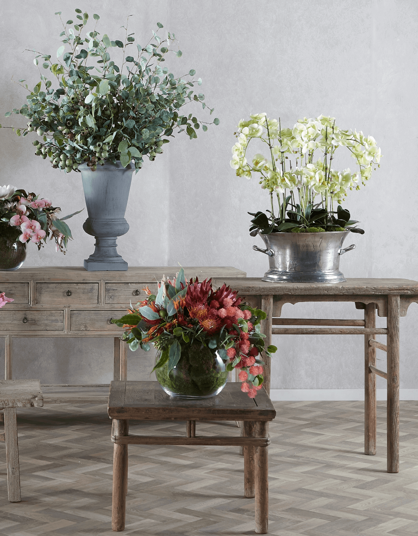 lifelike flower arrangements standing on tables