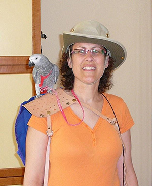 Sharon and Clover, a smart African Grey standing on shoulder