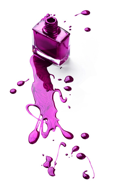 A vibrant purple liquid splashes onto a pristine white surface, creating a captivating and colorful display.